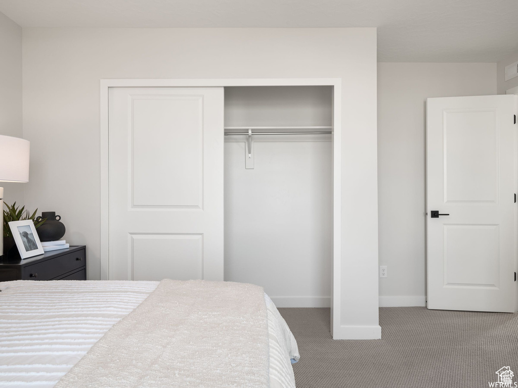 Bedroom featuring a closet and carpet flooring