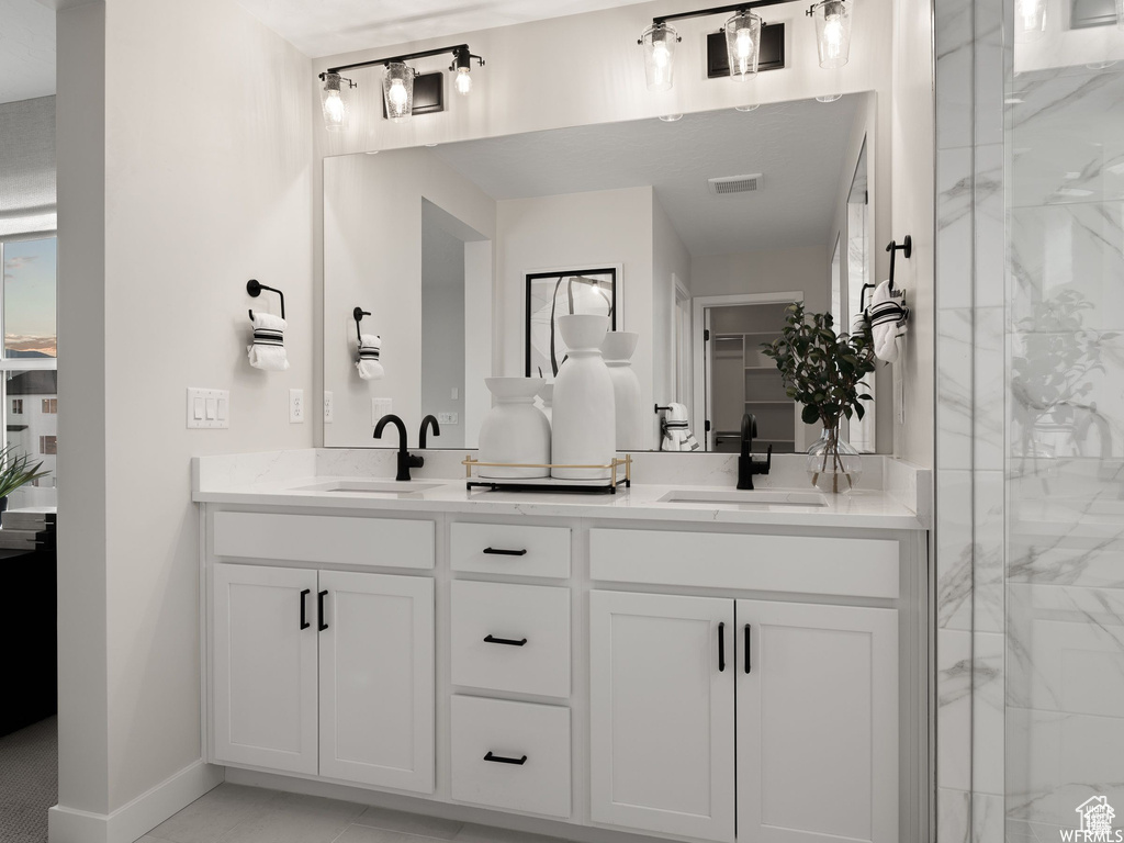 Bathroom featuring walk in shower and vanity