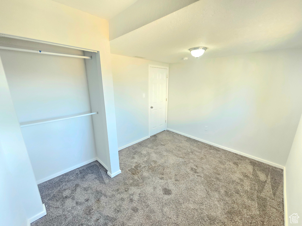 Unfurnished bedroom featuring a closet and carpet flooring