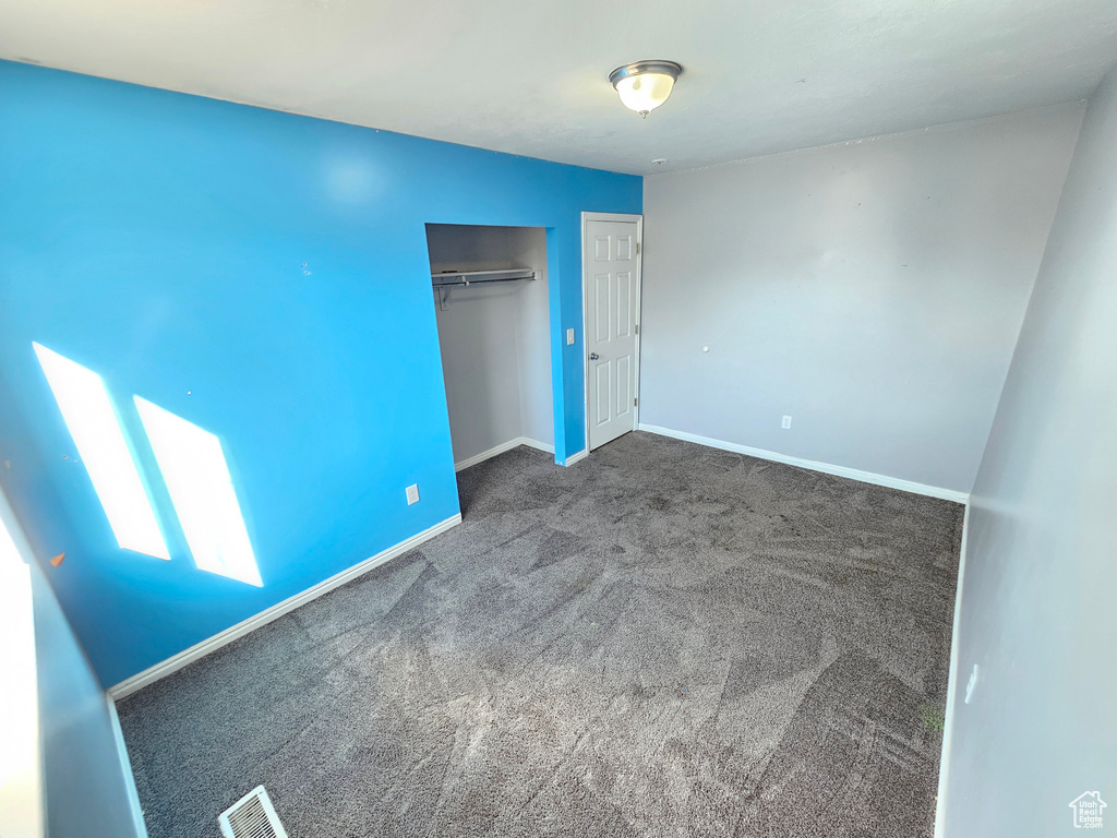 Unfurnished bedroom featuring a closet and carpet flooring