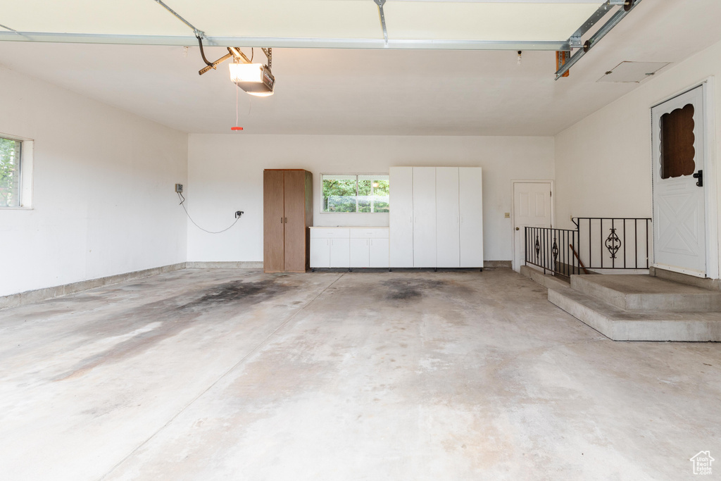 Garage featuring a garage door opener