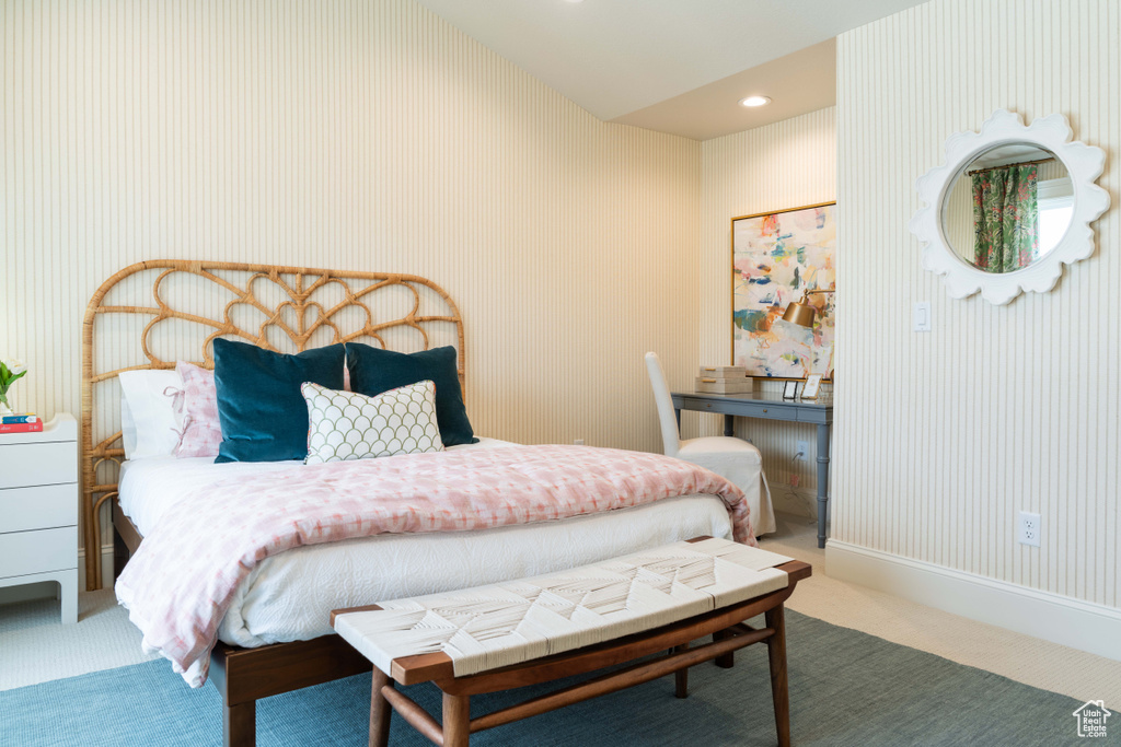 Bedroom with carpet floors and vaulted ceiling