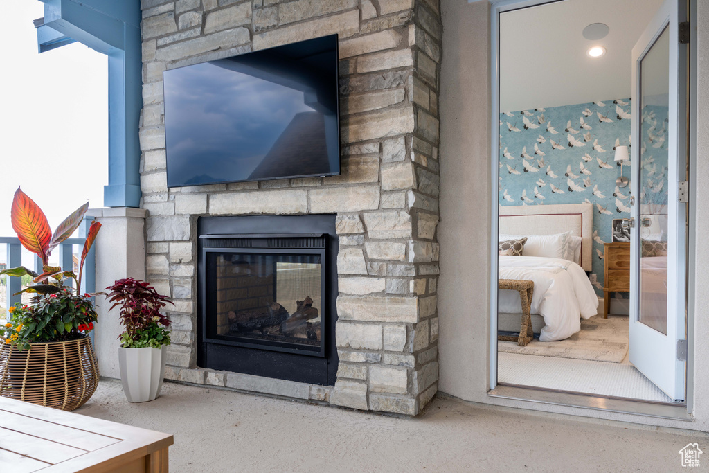 Living room featuring plenty of natural light and a stone fireplace