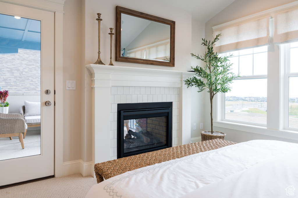 Carpeted bedroom featuring lofted ceiling