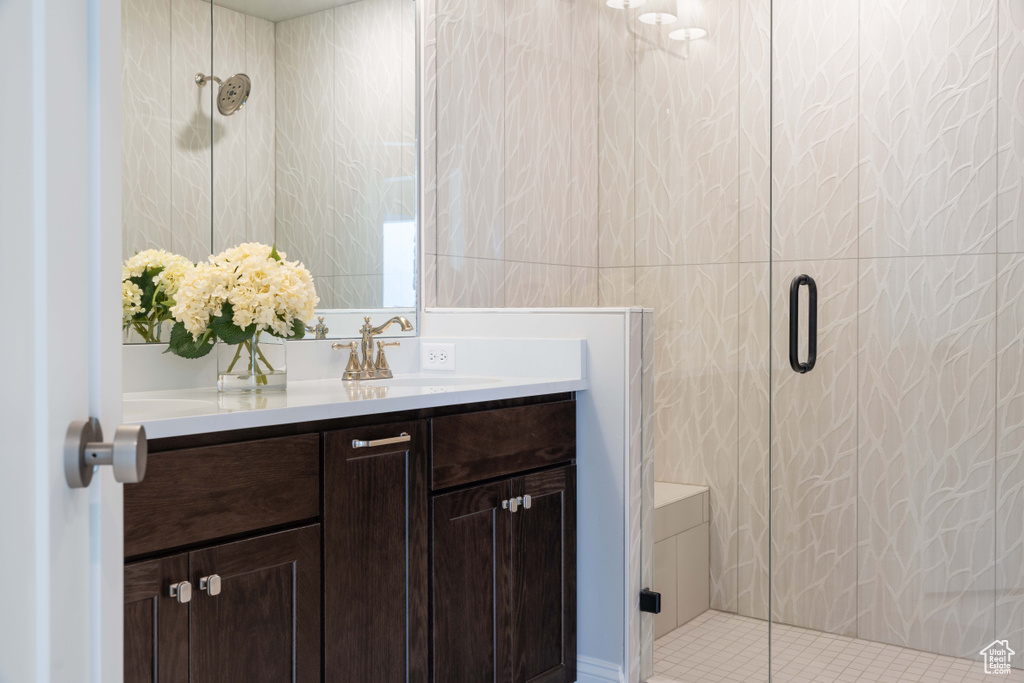 Bathroom with a shower with door and vanity