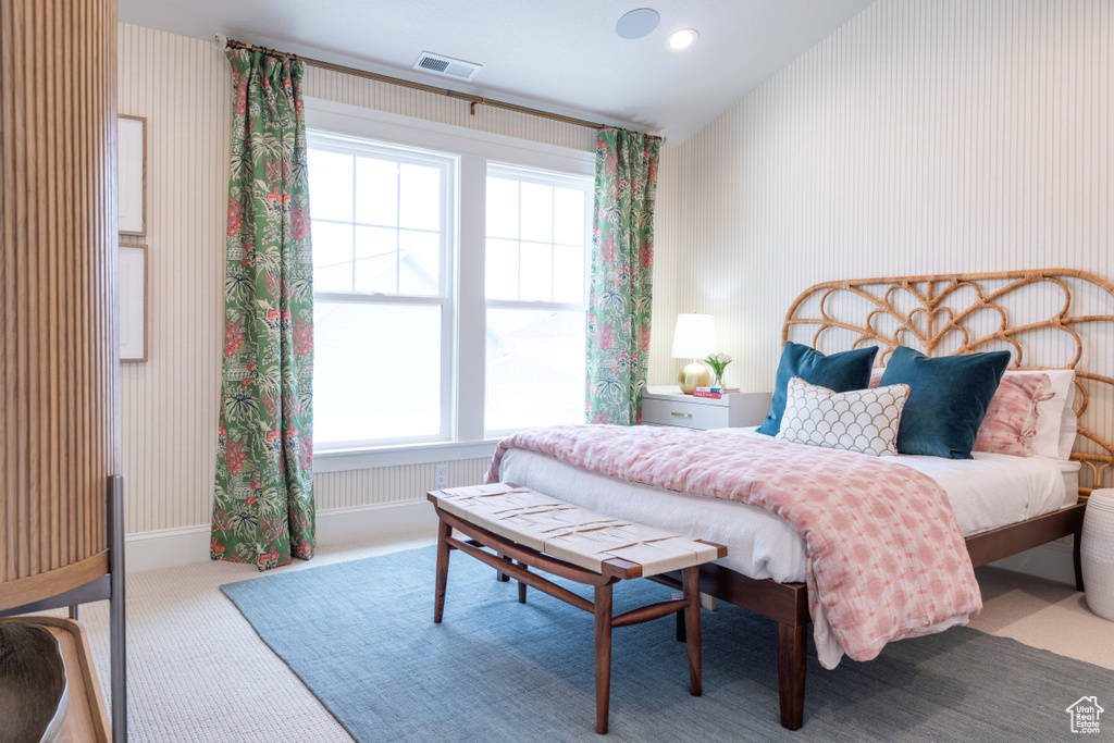 Bedroom with lofted ceiling and carpet flooring