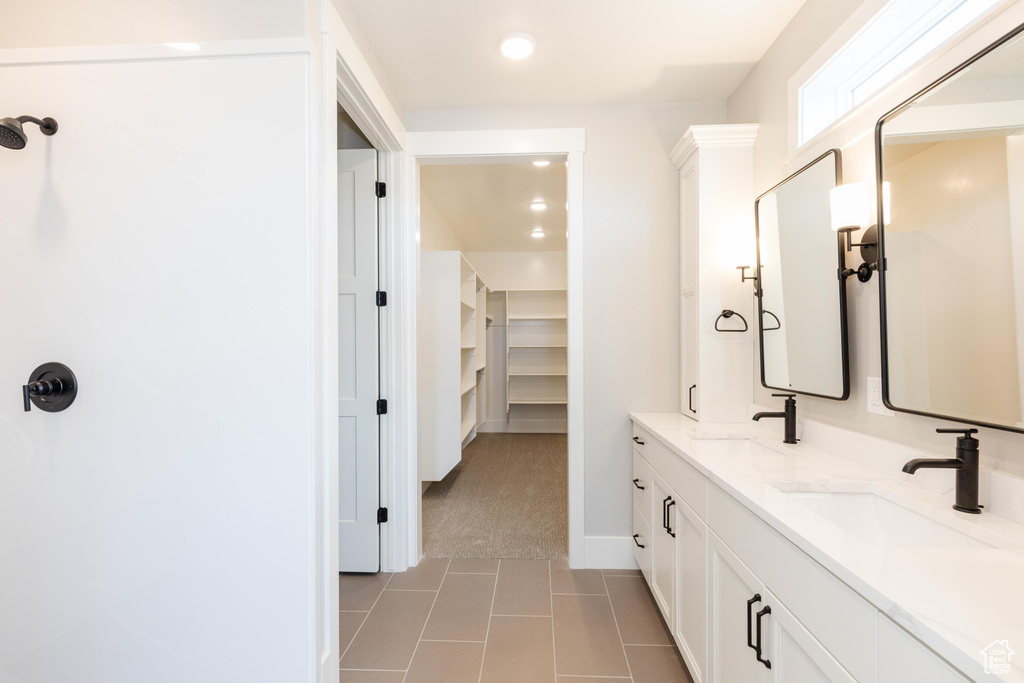 Bathroom with tile patterned floors and vanity