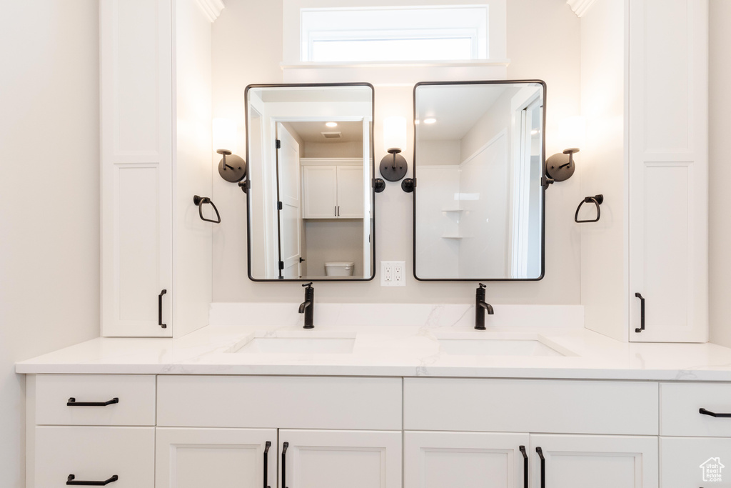 Bathroom featuring ornamental molding and vanity