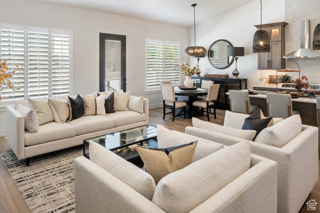 Living room featuring a notable chandelier and light hardwood / wood-style flooring