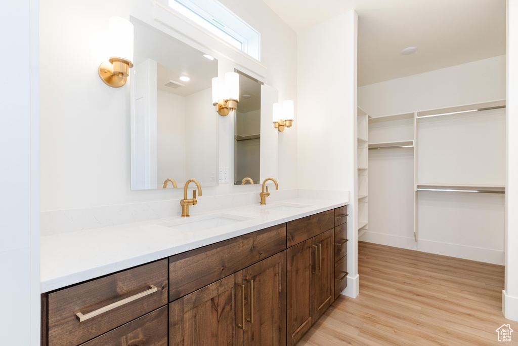 Bathroom with vanity, hardwood / wood-style floors, and toilet