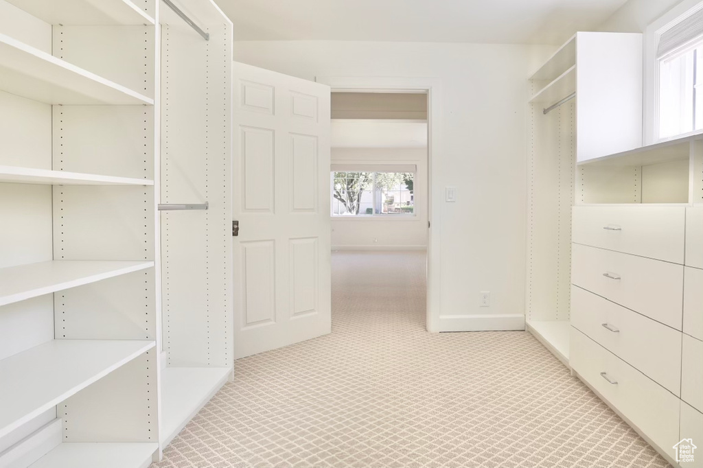 Walk in closet featuring light carpet