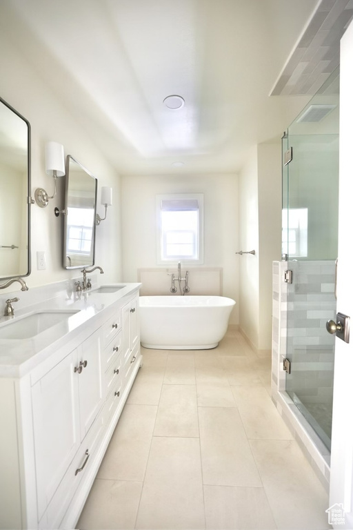 Bathroom with tile patterned flooring, plus walk in shower, and vanity