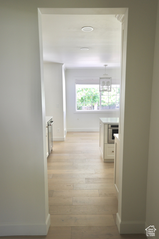 Corridor with light wood-type flooring