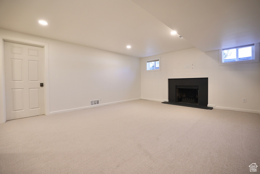 Basement featuring light carpet