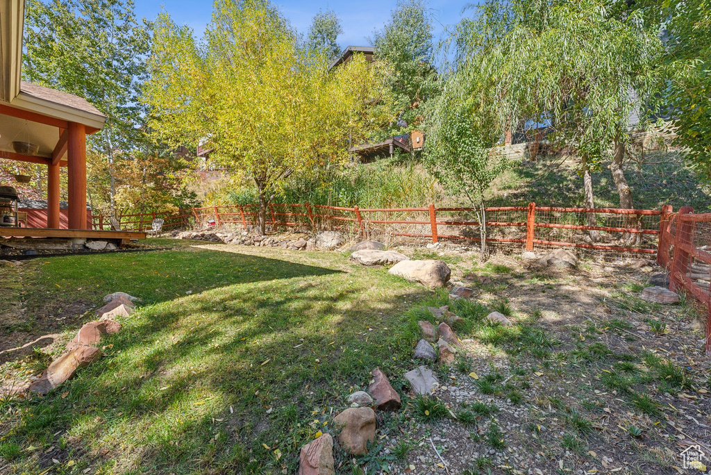 View of yard with a wooden deck