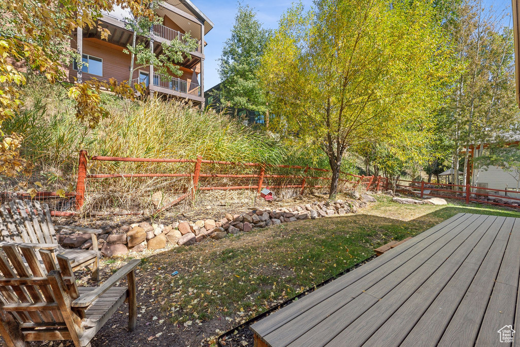 View of yard with a balcony