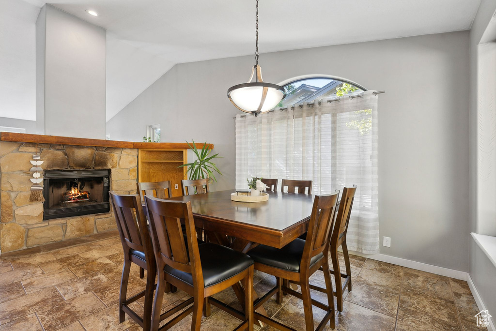 Dining area with a fireplace and lofted ceiling