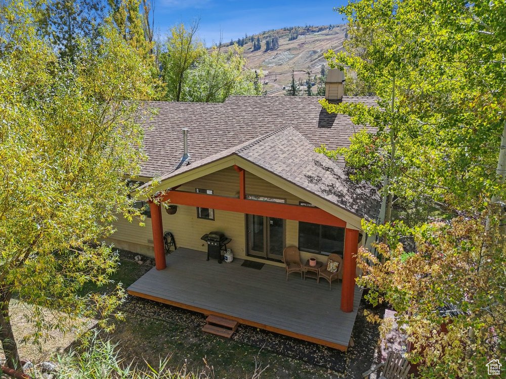 Back of house with a deck with mountain view