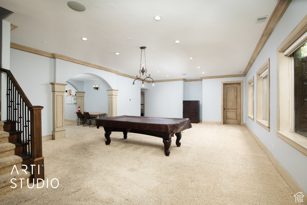 Rec room with light carpet, crown molding, ornate columns, and pool table