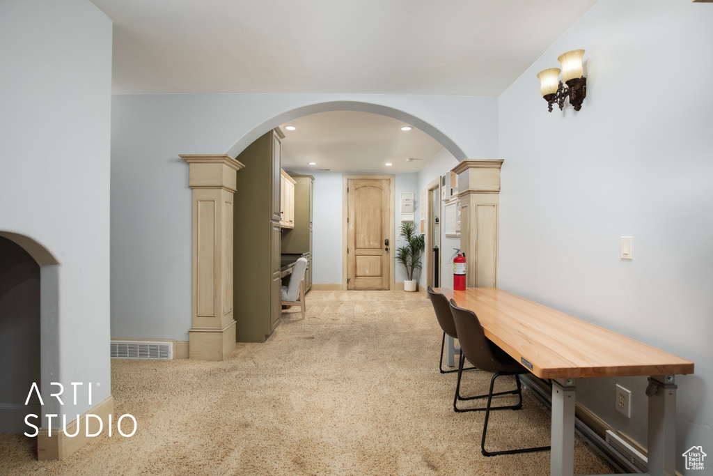 Interior space with light carpet and decorative columns