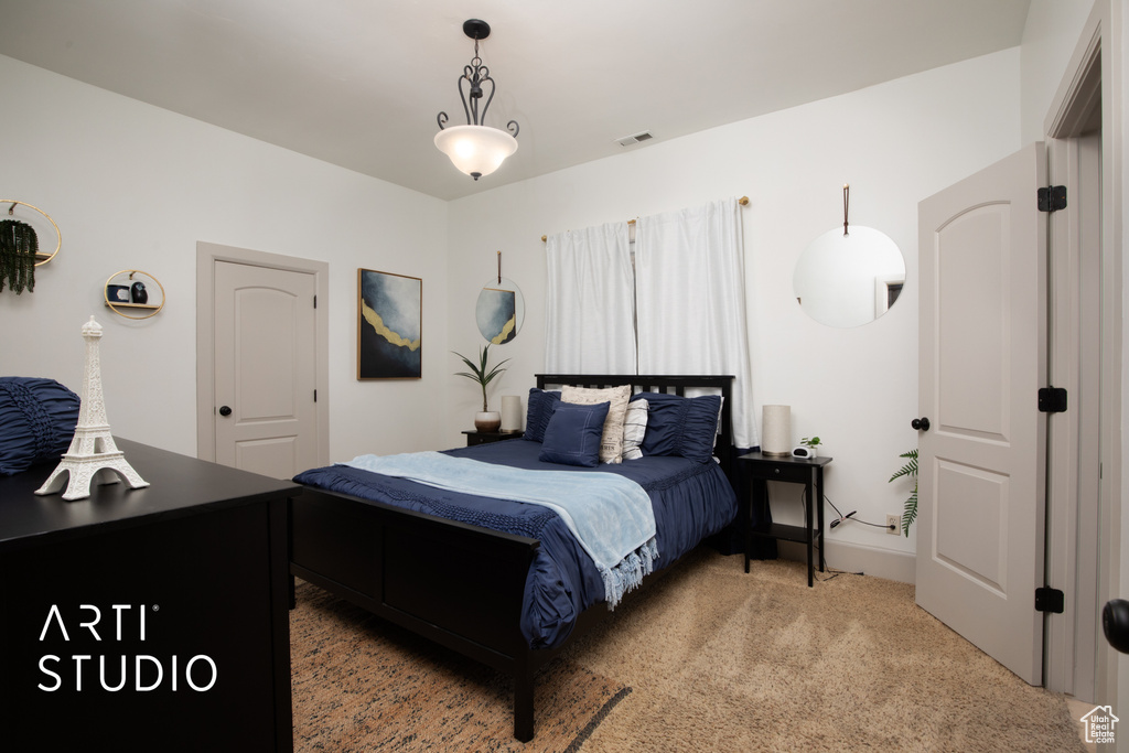 Bedroom featuring light colored carpet