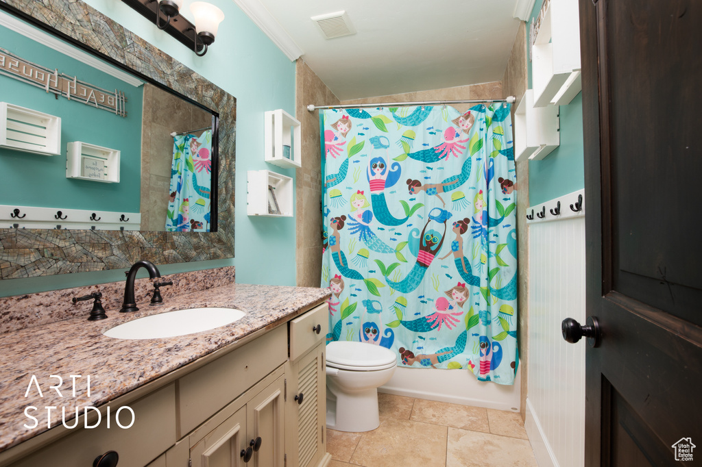 Full bathroom with crown molding, shower / tub combo, vanity, and toilet