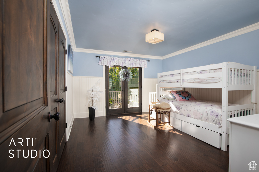 Bedroom with dark wood-type flooring, french doors, and ornamental molding