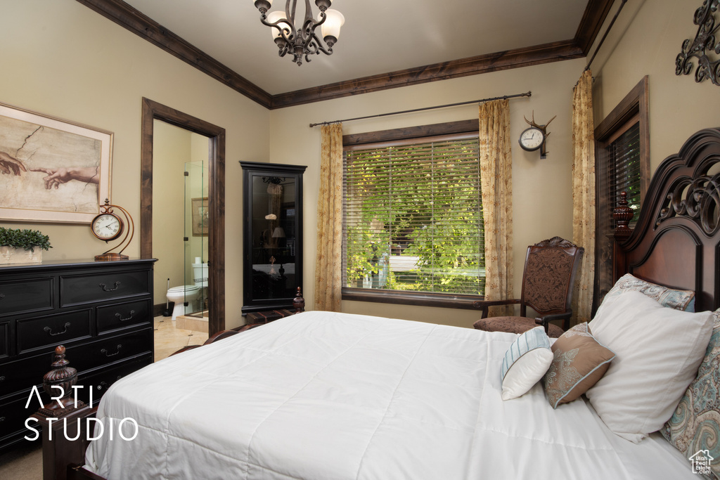 Bedroom featuring crown molding, a chandelier, and ensuite bath