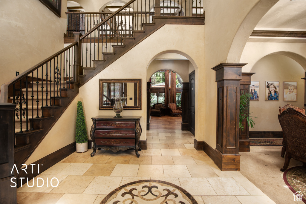 Entryway featuring decorative columns and a high ceiling