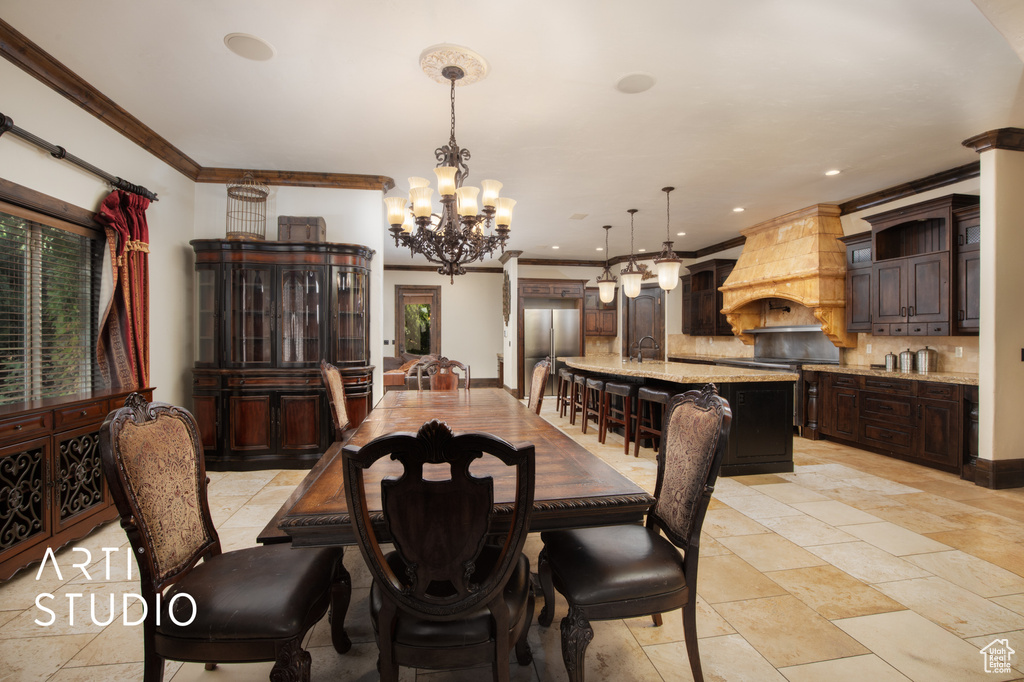 Dining room with a notable chandelier and crown molding