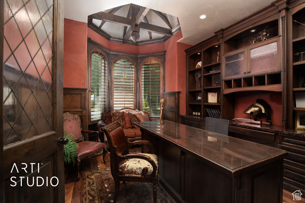 Office space with beam ceiling, crown molding, coffered ceiling, and wood-type flooring
