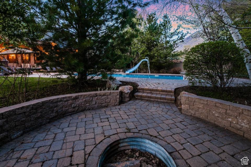 Patio terrace at dusk featuring a gazebo