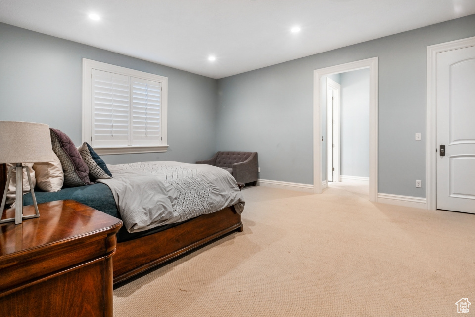 Bedroom featuring light colored carpet