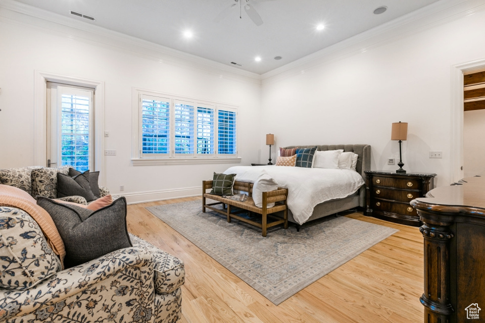 Bedroom with ornamental molding, hardwood / wood-style floors, and ceiling fan