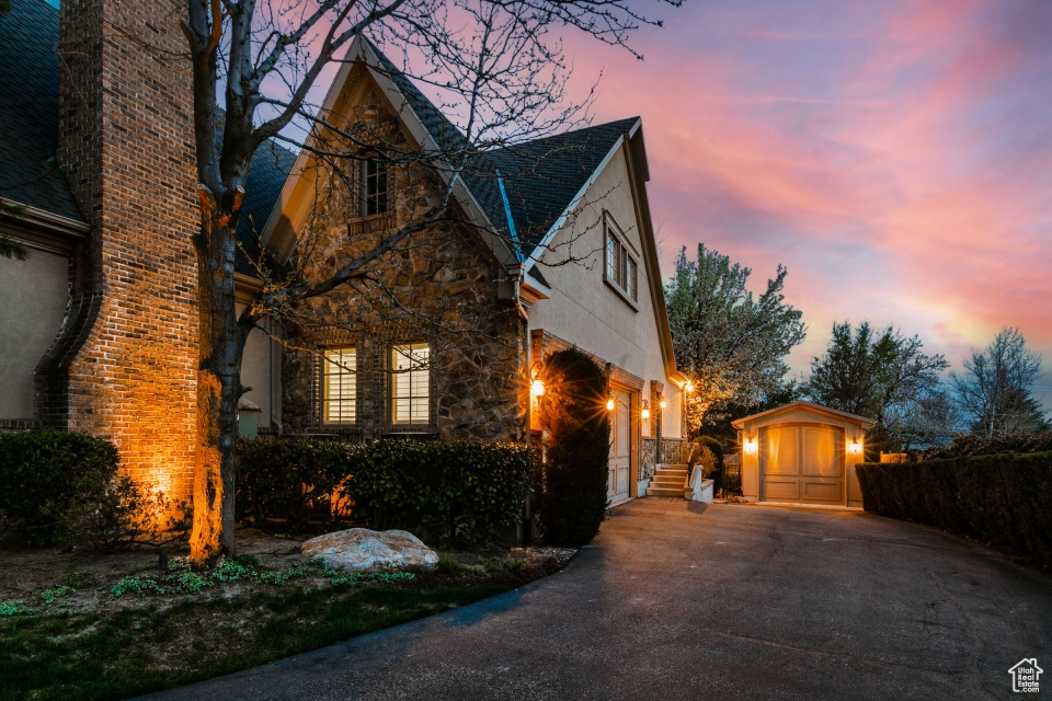 Property exterior at dusk with a storage unit