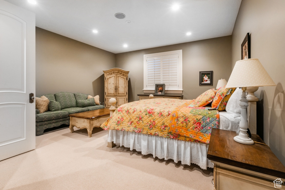 Bedroom featuring light colored carpet