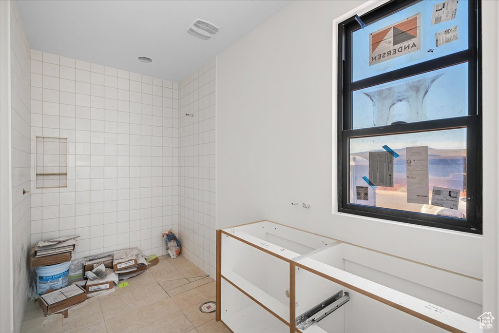 Bathroom with tile patterned flooring and tile walls