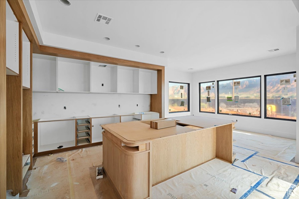 Kitchen featuring white cabinets and a center island