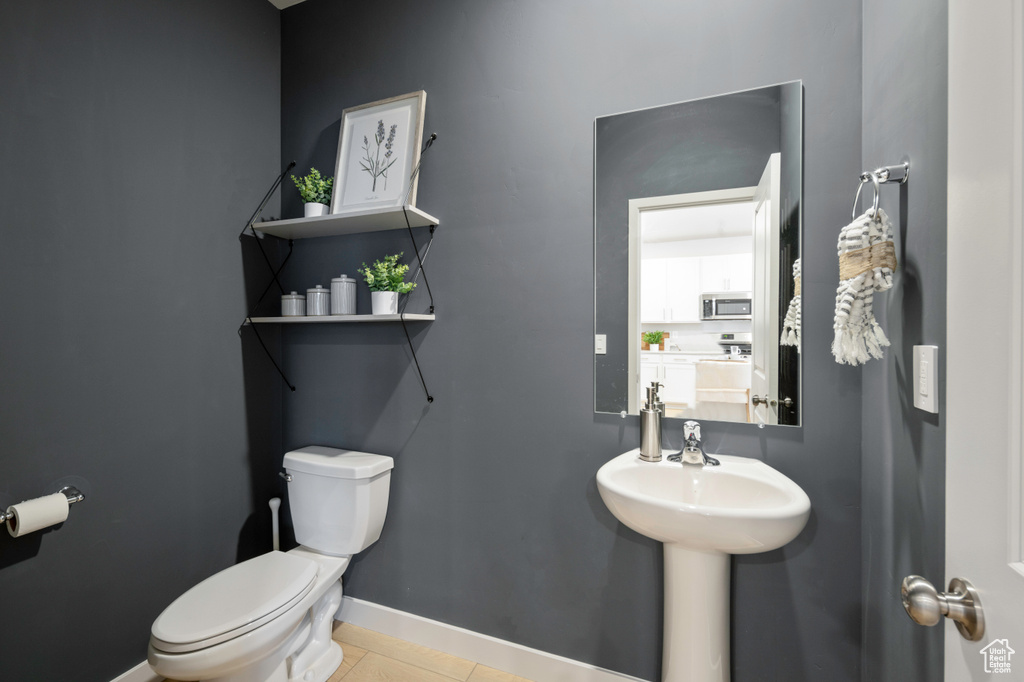 Bathroom with toilet and tile patterned floors