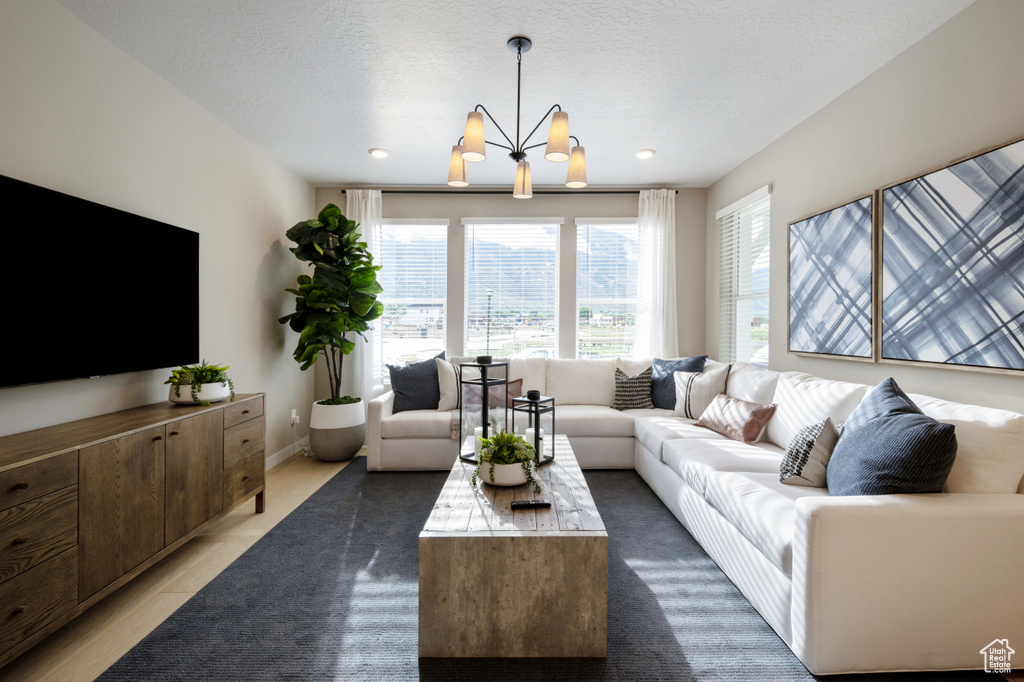 Tiled living room with a chandelier and a textured ceiling