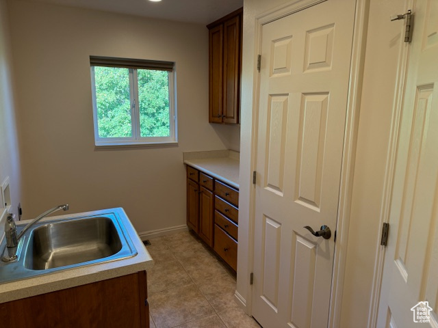 Kitchen with sink and light tile patterned floors