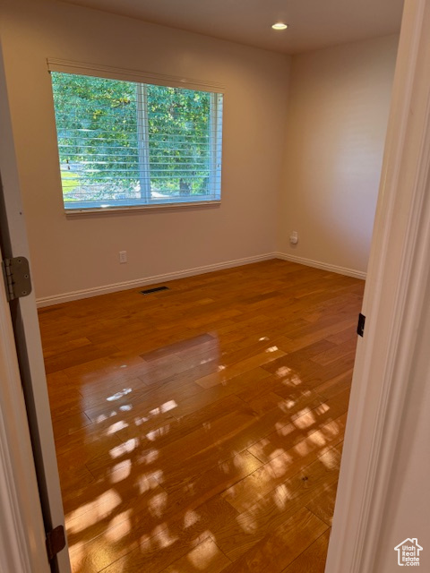 Unfurnished room featuring wood-type flooring