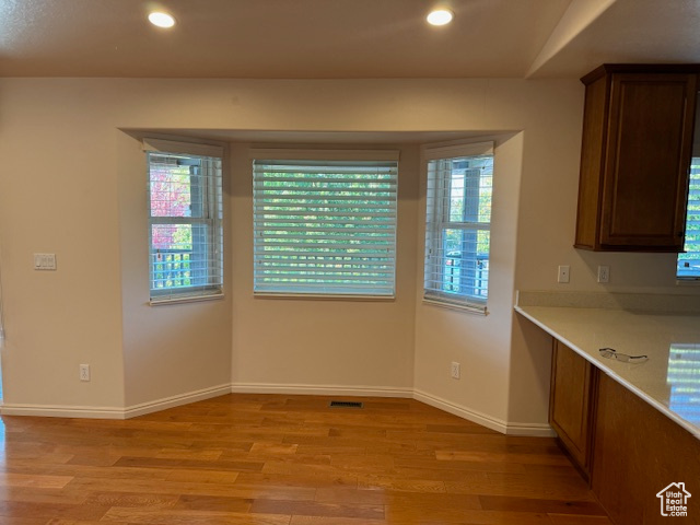 Unfurnished dining area featuring light wood-type flooring