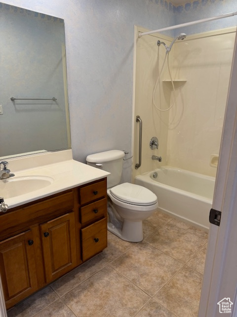 Full bathroom featuring vanity, bathing tub / shower combination, toilet, and tile patterned floors