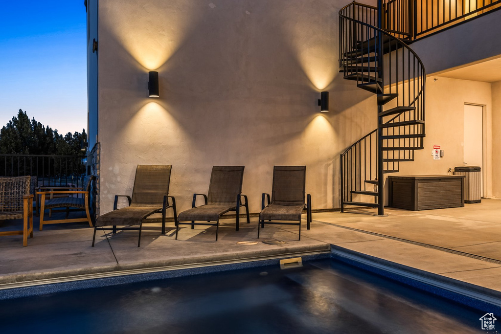 Pool at dusk with a patio area