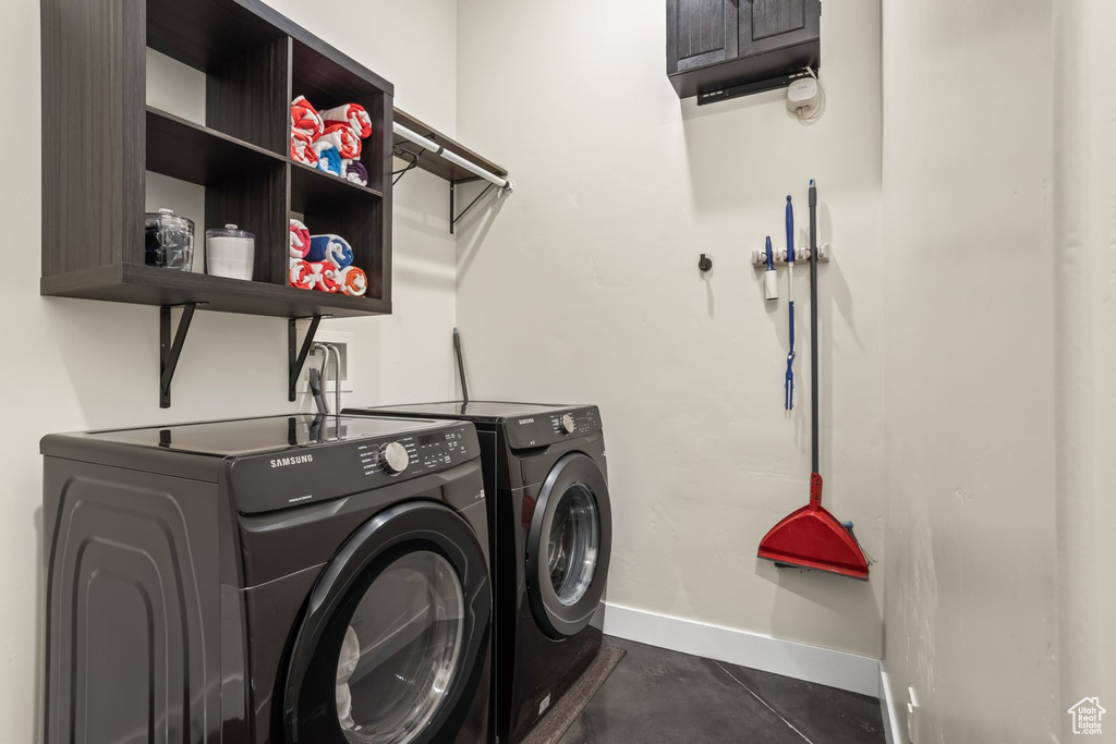 Clothes washing area with washer and dryer and cabinets