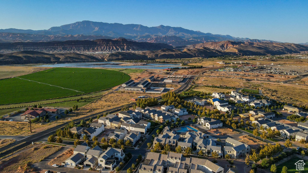 Birds eye view of property with a water and mountain view