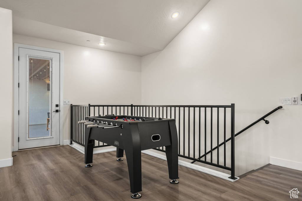 Rec room featuring dark hardwood / wood-style floors and vaulted ceiling