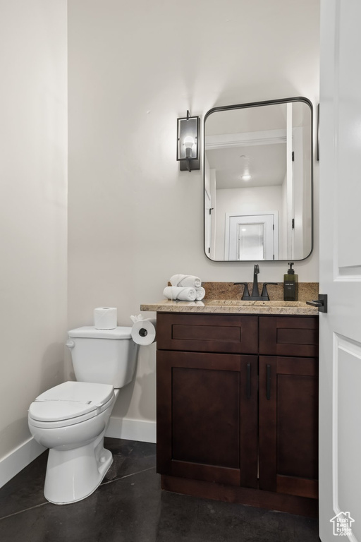 Bathroom with tile patterned flooring, vanity, and toilet