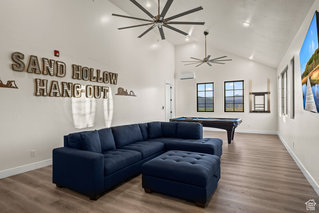 Living room with ceiling fan, hardwood / wood-style flooring, pool table, and high vaulted ceiling